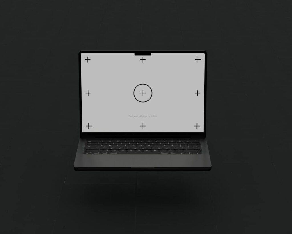 Floating laptop with calibration marks on black background, studio shot.